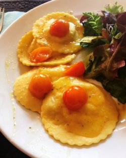 Open Hand crab corn ravioli mixed greens with peach and almond dressin