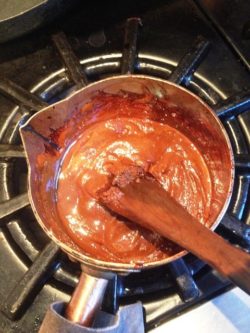 dark muscovado caramel in a copper sugar pan in KD kitchen