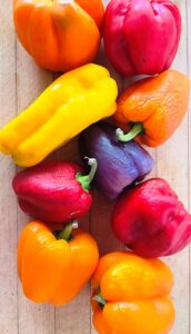 Red and yellow peppers on a kitchen counter, photo by Nancy Pollard for Kitchen Detail