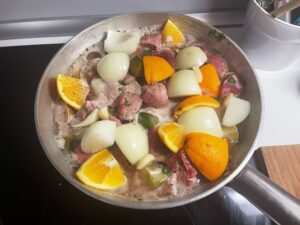 Carnitas beginning to cook in a Bologna kitchen